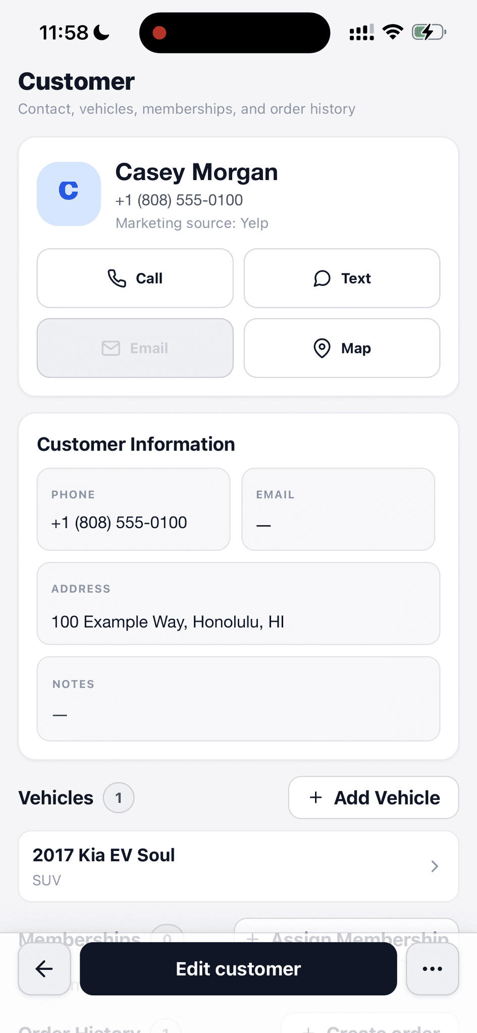 Fictional customer profile showing contact actions, address, marketing source, and a linked vehicle